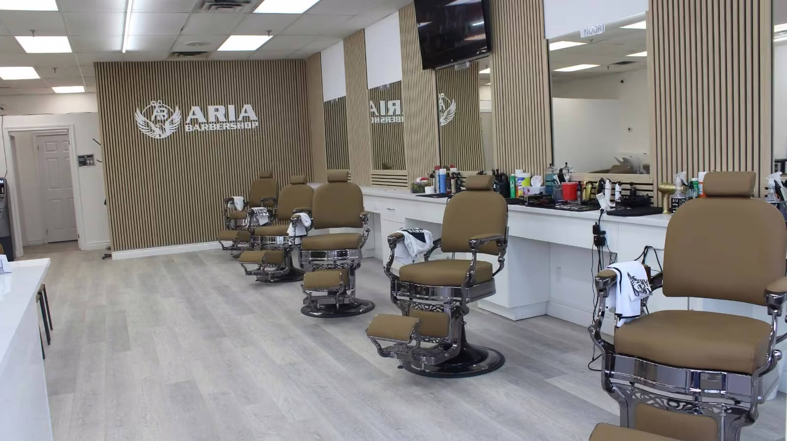 Barber performing a skin fade at Aria Barbershop